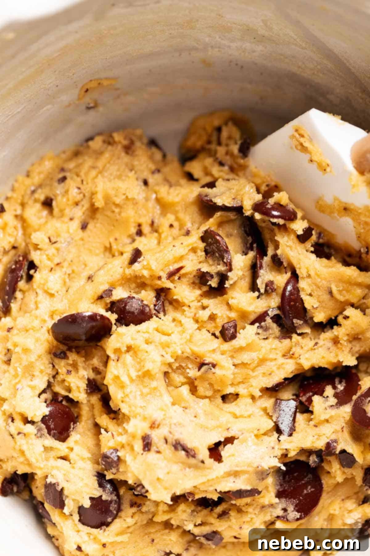 A mixing bowl with the chocolate chip cookie dough before scooping.