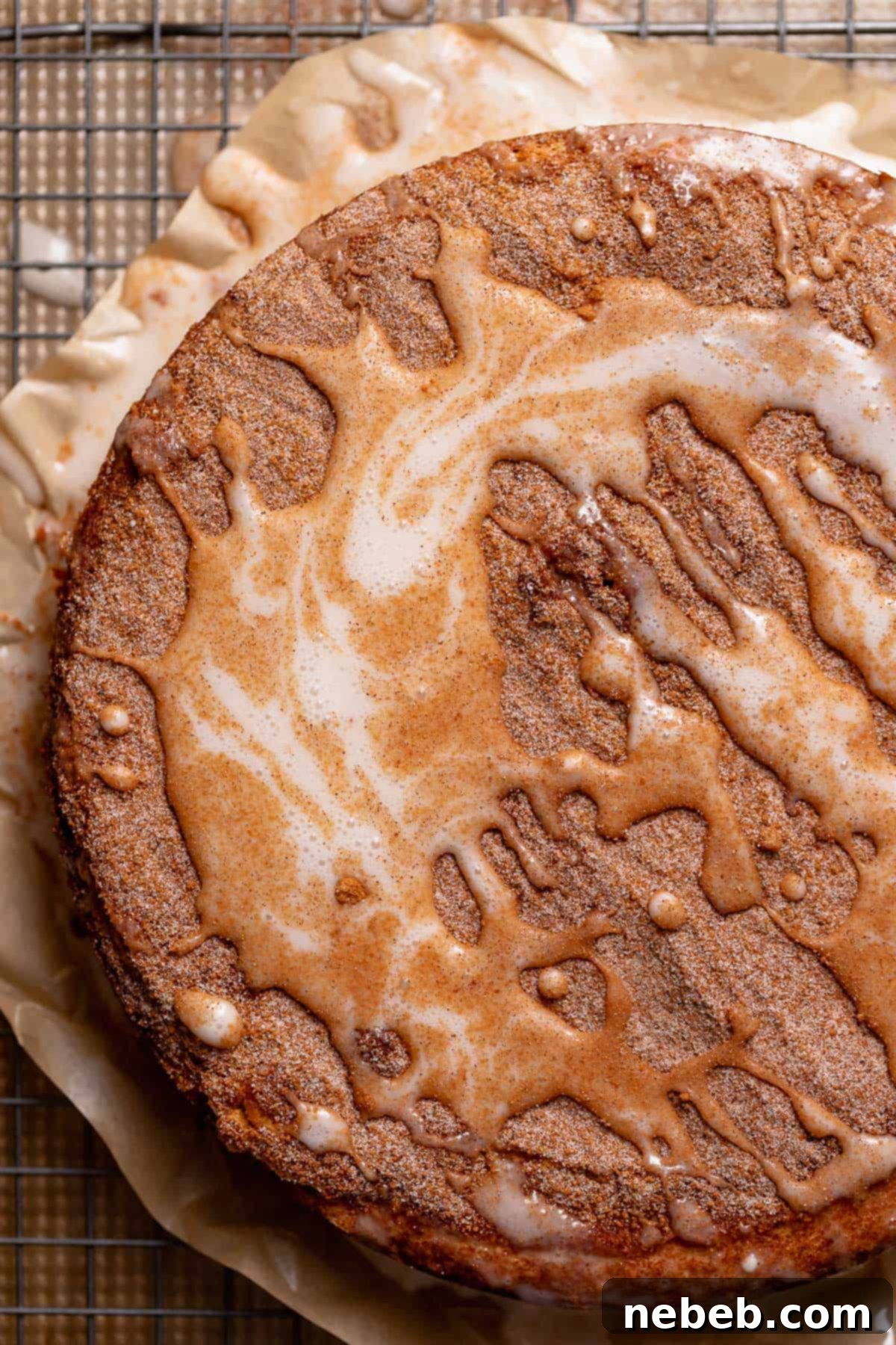 The baked coffee cake on a wire rack drizzled with vanilla icing.