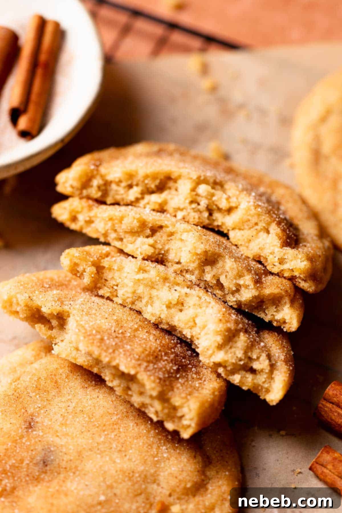 Perfect Brown Butter Snickerdoodles 2 Brown butter snickerdoodles broken in half to show the soft and chewy texture.