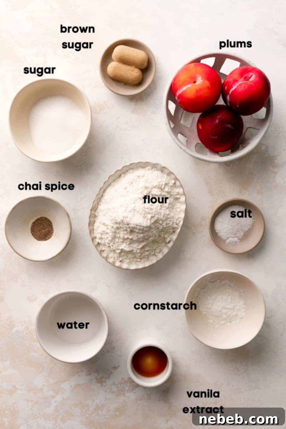 Ingredients for plum bars laid out in small bowls, including plums, sugar, butter, and flour.