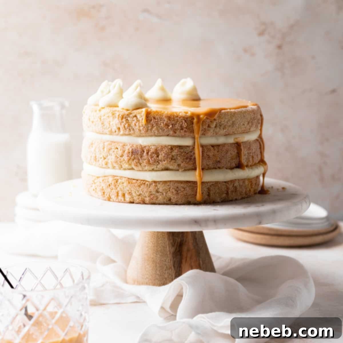 Cinnamon Sugar Dream Cake 7 a whole churro cake on a cake stand.