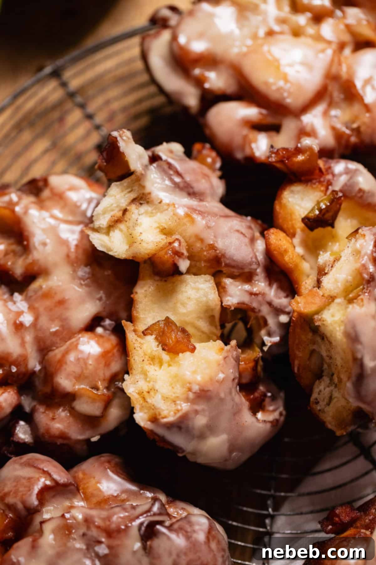 Homemade Apple Fritters So Good You Will Skip The Bakery 11 A fritter broken in half to show the soft centers and apples.