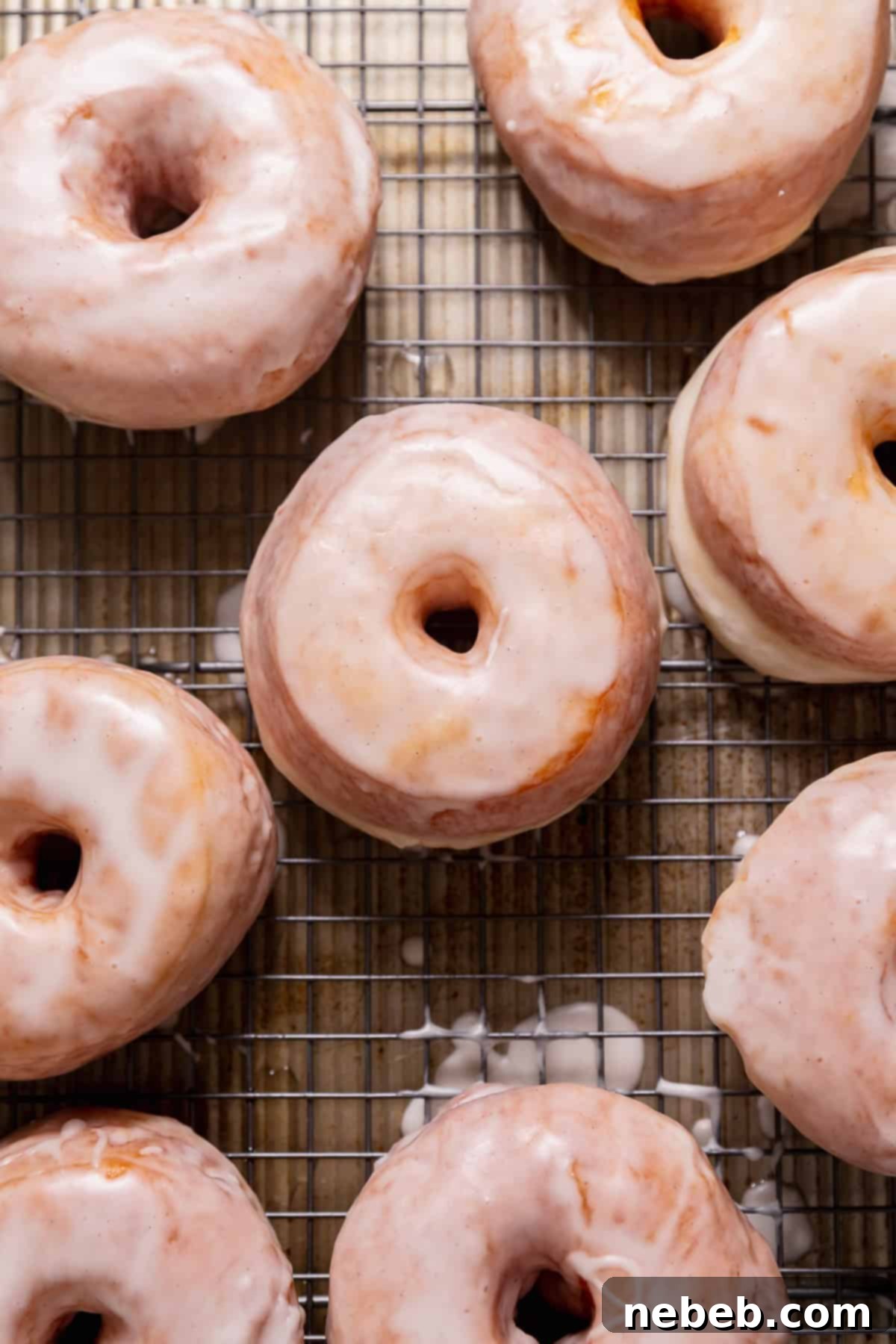 Pillowy Milk Bread Donuts 8 Donuts with vanilla icing sitting on a wire rack.