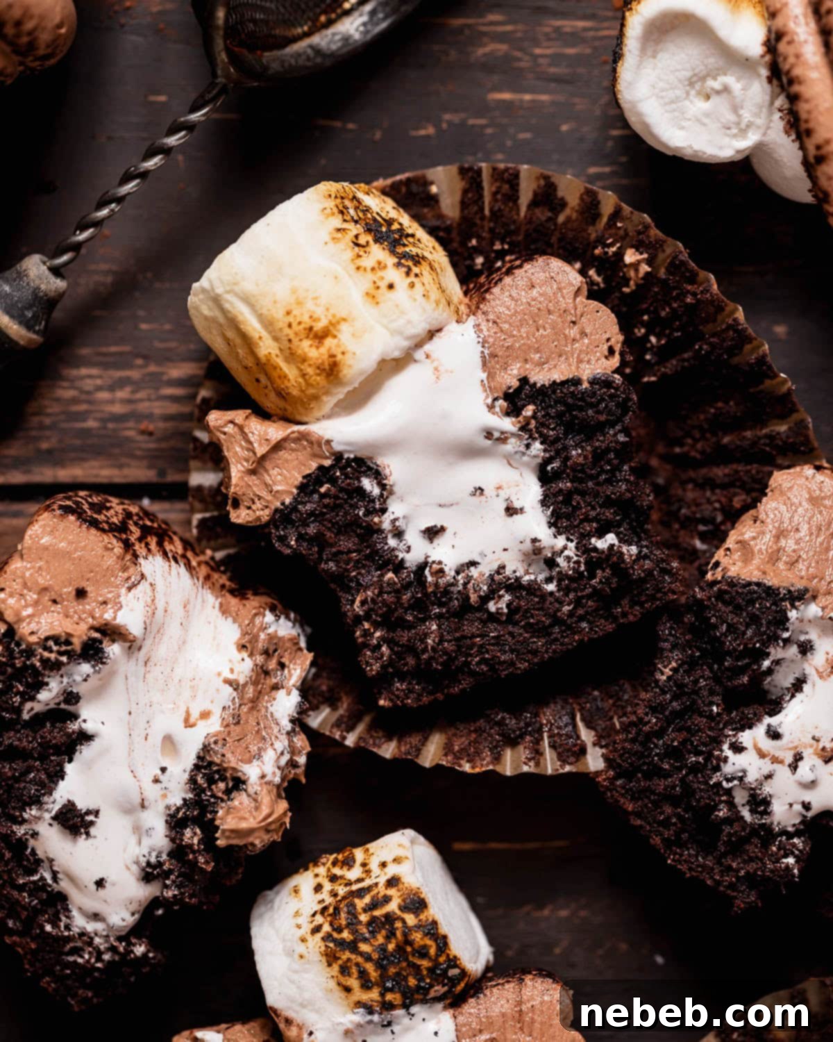 Golden Marshmallow-Stuffed Cocoa Cupcakes 12 Hot chocolate cupcakes cut in half to show the marshmallow filling.