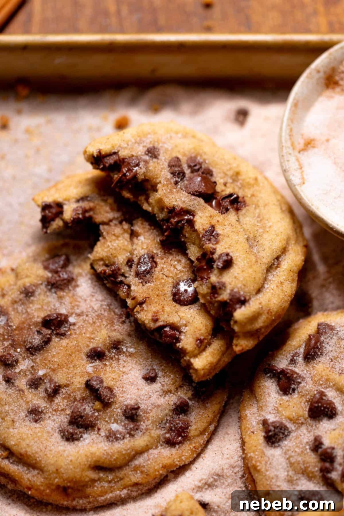 Decadent Chocolate Chip Snickerdoodle Dream Cookies 9 A chocolate chip snickerdoodle cookie broken in half with a soft, gooey center.