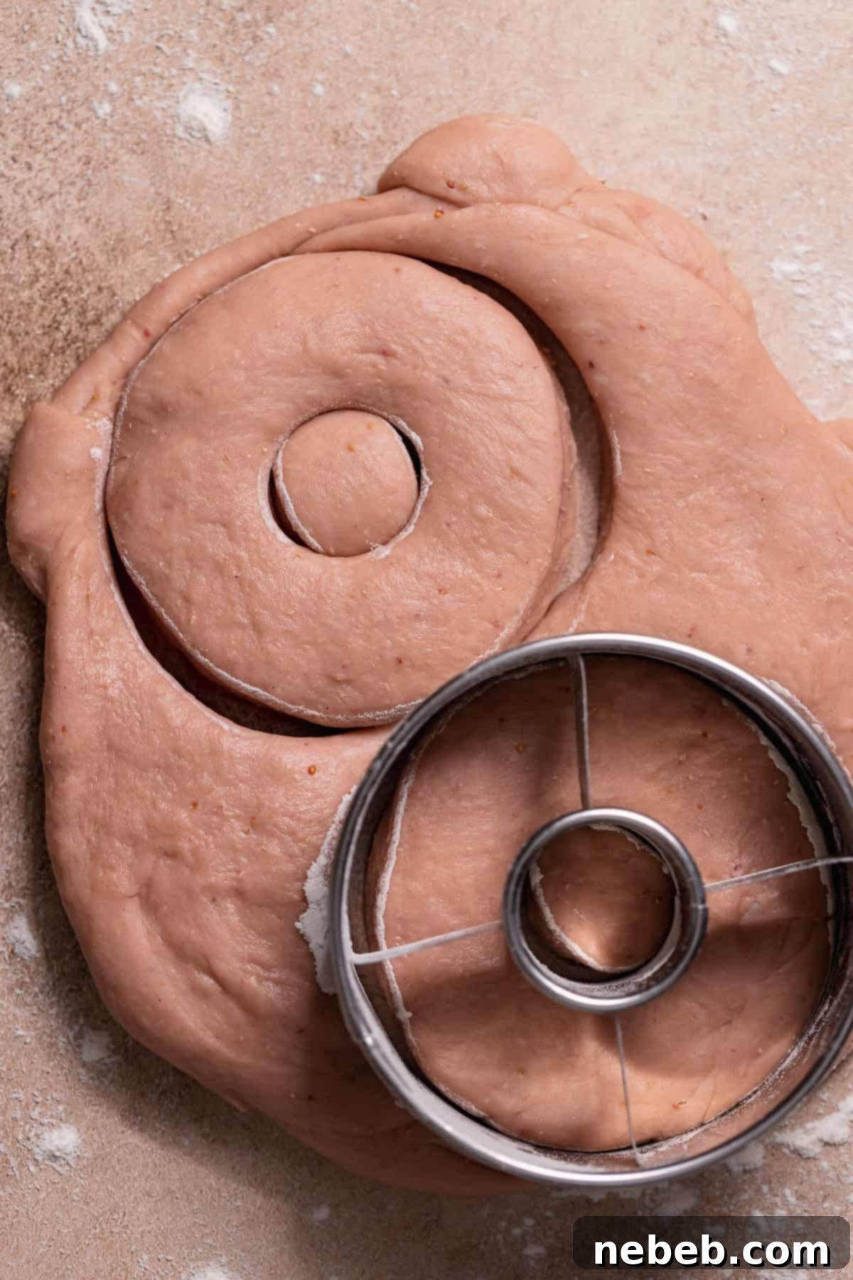 Triple Strawberry Dream Donuts 5 Rolled-out dough with donut shapes cut using a round cutter.