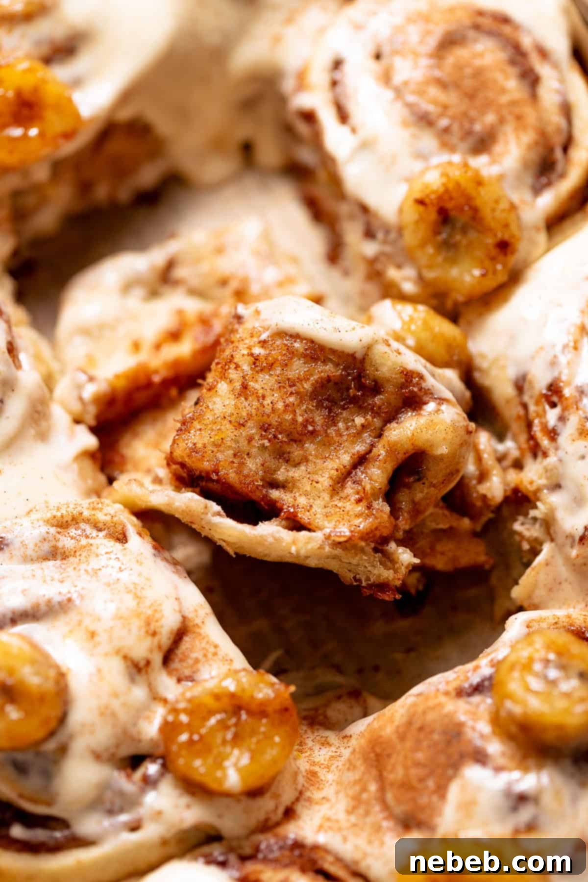 Banana Bread Cinnamon Rolls 11 Close-up bite shot of a banana cinnamon roll showing soft interior crumb.